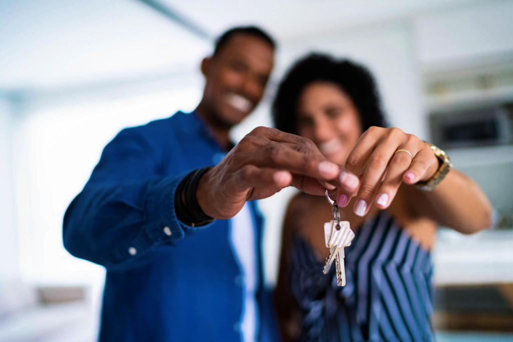 Man and woman holding a house key.