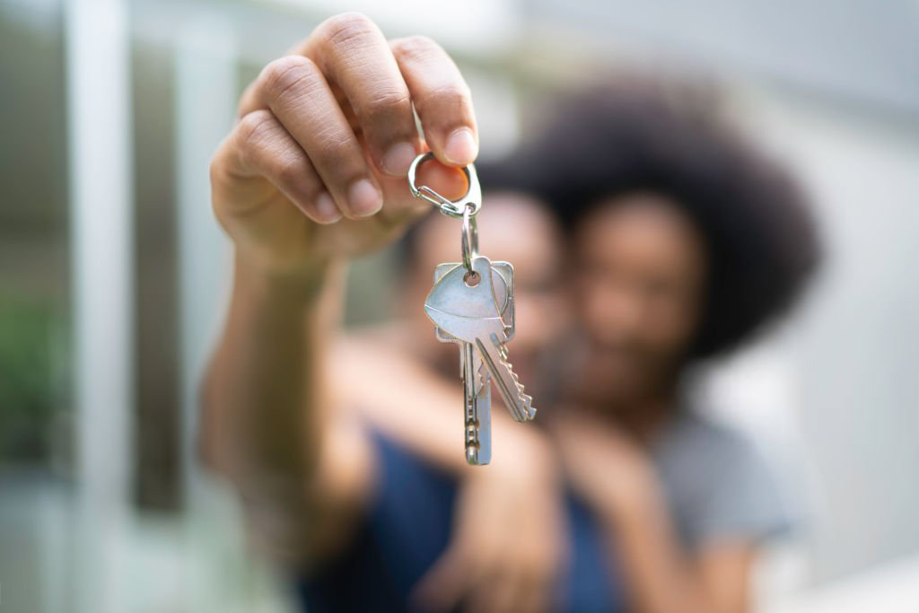 Two people blurred with a key in focus